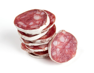 stacked sliced salami isolated on white