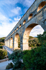 Side view of Pont du Gard and tourists path