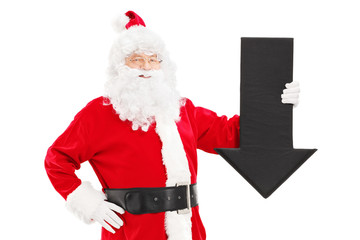 Smiling Santa Claus holding a big black arrow pointing down
