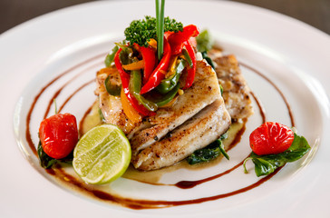 Fillet sea bass meuniere with vegetable and potatoes.