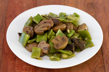 green beans with mushrooms on plate