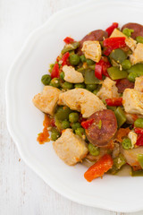 chicken with sausages and vegetables on plate