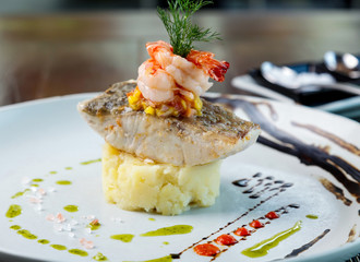 Fillet sea bass meuniere with vegetable and potatoes.