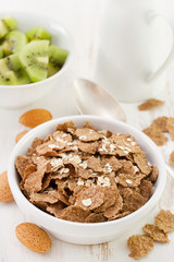 flakes in white bowl and kiwi