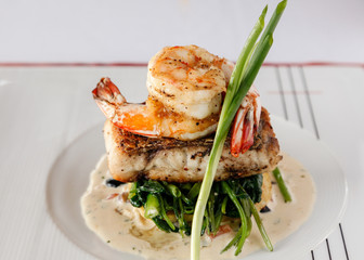 Fillet sea bass meuniere with vegetable and potatoes.