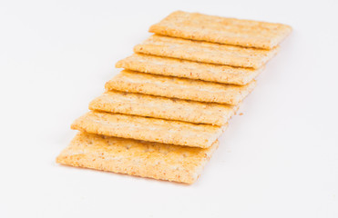 Fresh organic whole grain crackers on white background