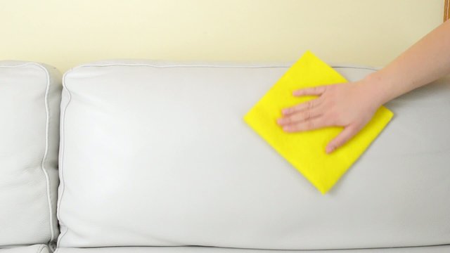 cleaning a beige sofa