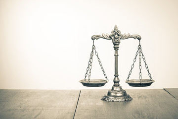 Law scales on table. Symbol of justice. Sepia photo
