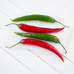 Red and green chili peppers, close-up, studio shot
