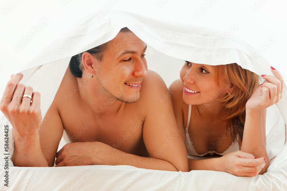 Wall mural couple lying together in bed