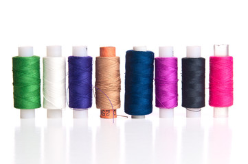 Few spools of thread on white background