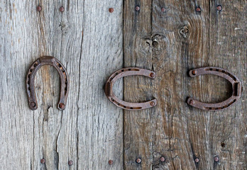 Old horseshoes on wooden background