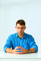 Portrait of a young confident businessman sitting 