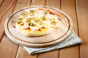 Mini pizza. homemade on wooden plate