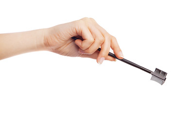 Female hand holding a makeup brush