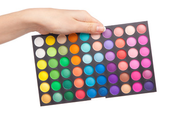 Female hand holding a makeup palette