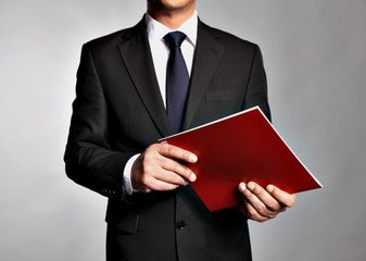 Businessman holds a booklet