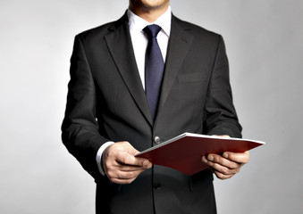 Bisnessman holds a booklet