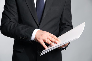 Businessman holds a booklet