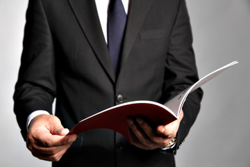 Businessman holds a booklet