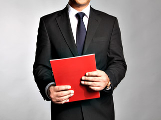 Bisnessman holds a booklet