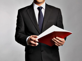 Bisnessman holds a booklet