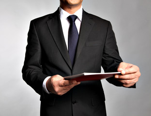 Bisnessman holds a booklet