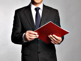 Bisnessman holds a booklet