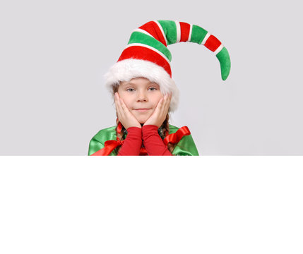 Girl in suit of Christmas elf with the banner