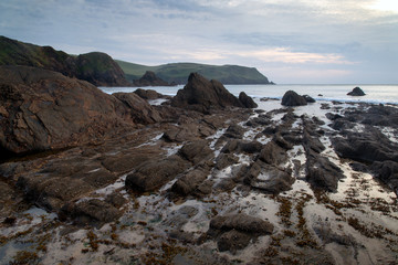 Hope Cove sunset landscape seascape with rocky coastline and lon