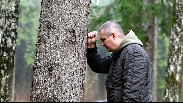 Depressed man leaning on a tree episode 1