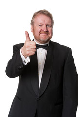 Positive man in tuxedo gives thumbs up