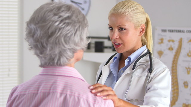 Doctor talking to elderly female patient