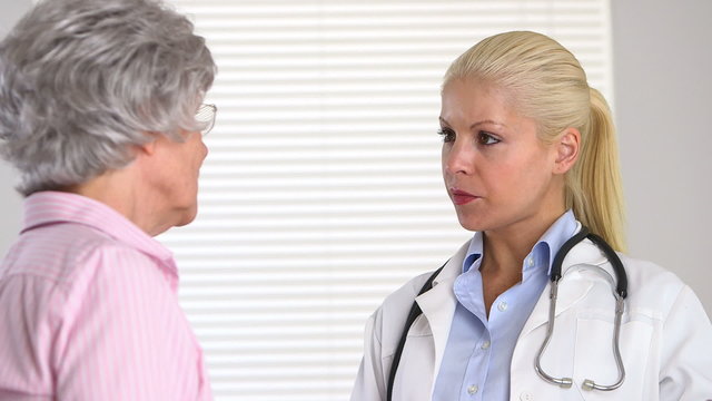 Close up of female doctor talking to older patient