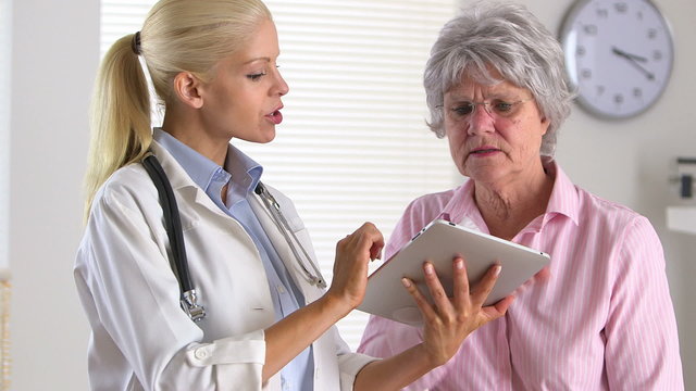 Patient listening to doctor with tablet computer