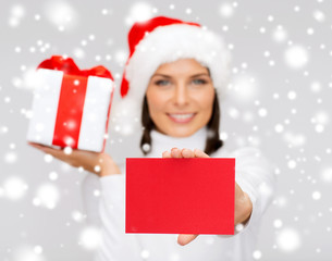 smiling woman in santa helper hat with postcard