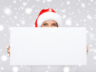 woman in santa helper hat with blank white board