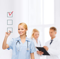 doctor or nurse drawing checkmark into checkbox