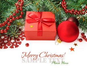 spruce branches with Christmas decorations and gift box