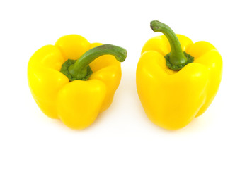 Two big yellow ripe bell peppers isolated on white close up