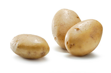 new  raw potatoes close-up on white background
