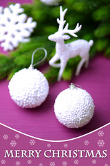 Christmas balls on fir tree, on color background