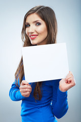 Fototapeta premium Teenager girl hold white blank paper. Young smiling woman show