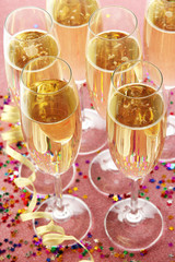 Glasses with champagne on shiny background