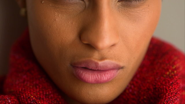 Extreme close up of black woman wearing red shawl