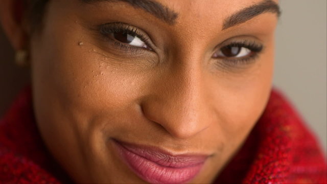 Close up of African American woman smiling into camera