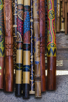 Close up view of a pile of didgeridoo musical instruments.