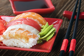 sushi and chopstick on a red plate