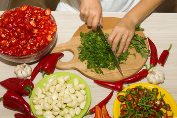 Cutting parsley and red chili pepper
