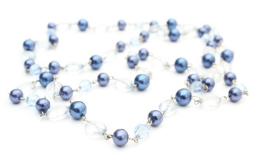 Blue, shiny necklace for the woman on white background